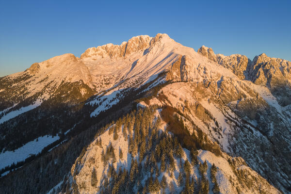 Aerial view of Monte Gulter and the Presolana massif after a winter snowfall at sunrise. Presolana pass, Castione della Presolana, Seriana Valley, Bergamo province, Lombardy, Italy.