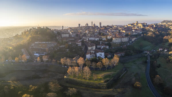 View of the rooftops, churches and towers of the Upper Town (Città Alta) of Bergamo city at sunrise. Bergamo, Lombardy, Italy.