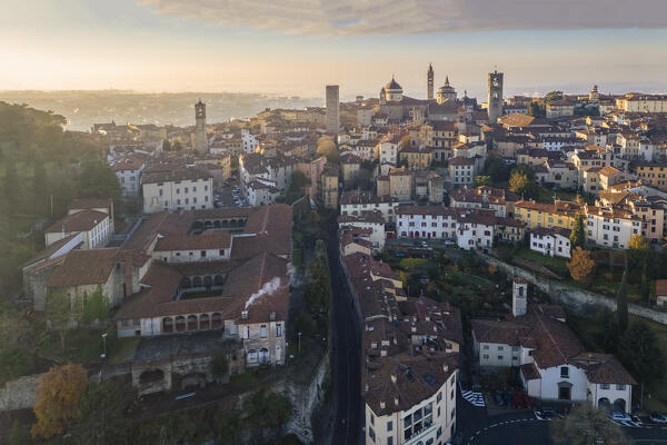 View of the rooftops, churches and towers of the Upper Town (Città Alta) of Bergamo city at sunrise. Bergamo, Lombardy, Italy.
