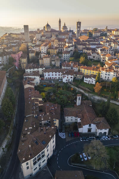 View of the rooftops, churches and towers of the Upper Town (Città Alta) of Bergamo city at sunrise. Bergamo, Lombardy, Italy.