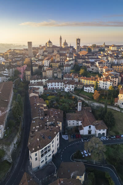 View of the rooftops, churches and towers of the Upper Town (Città Alta) of Bergamo city at sunrise. Bergamo, Lombardy, Italy.