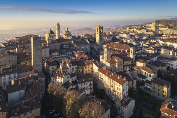 View of the rooftops, churches and towers of the Upper Town (Città Alta) of Bergamo city at sunrise. Bergamo, Lombardy, Italy.