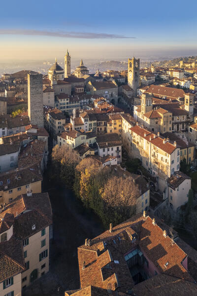 View of the rooftops, churches and towers of the Upper Town (Città Alta) of Bergamo city at sunrise. Bergamo, Lombardy, Italy.