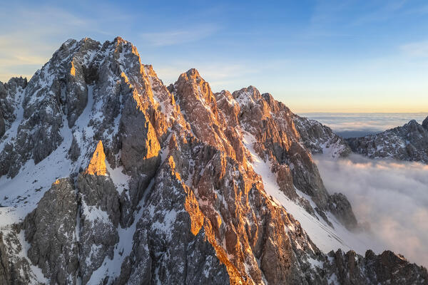 Aerial view of the Pizzo Camino mount at sunset in winter. Schilpario, Val di Scalve, bergamo district, Lombardy, Italy.