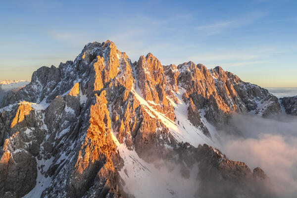 Aerial view of the Pizzo Camino mount at sunset in winter. Schilpario, Val di Scalve, bergamo district, Lombardy, Italy.
