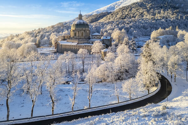 Aerial view of the dome of the upper basilica of the Sanctuary of Oropa in winter at sunrise. Biella, Biella district, Piedmont, Italy, Europe.