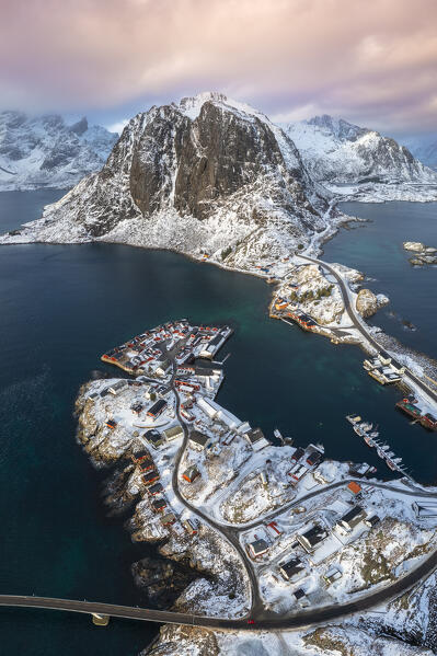 Aerial view of the Hamnøya island and the Lilandstinden mountain in Reine Bay during winter. Lofoten Islands, Norway.