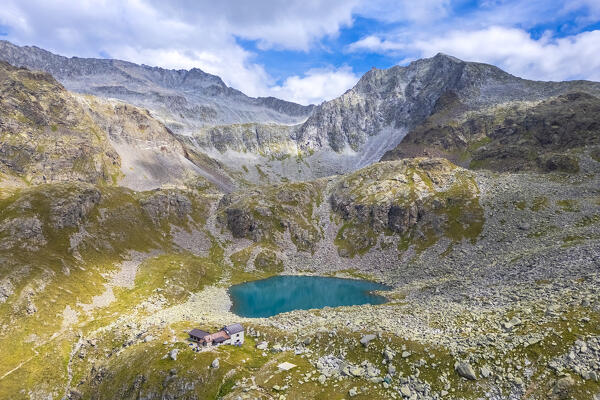 View of the Franco Tonolini refuge and Lake Rotondo in the beautiful Val Miller. Sonico, Val Camonica, Brescia district, Lombardy, Italy.