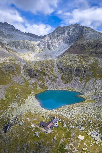 View of the Franco Tonolini refuge and Lake Rotondo in the beautiful Val Miller. Sonico, Val Camonica, Brescia district, Lombardy, Italy.