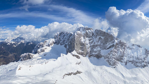 Aerial view of the snow-covered north face of the Presolana mountain in winter. Val di Scalve, Bergamo district, Lombardy, Italy, Southern Europe.