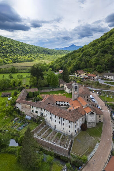 Aerial view of the ancient Badia di San Gemolo in Ganna on a spring day. Valganna, Varese district, Lombardy, Italy.