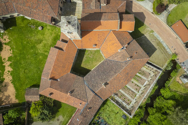Aerial view of the ancient Badia di San Gemolo in Ganna on a spring day. Valganna, Varese district, Lombardy, Italy.
