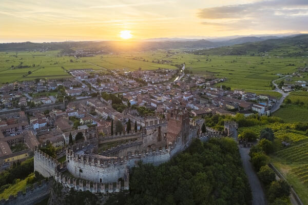 Aerial view of the Scaligero castle of Soave at sunset in summer. Verona district, Veneto, Italy, Europe.