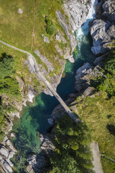 Aerial view of a small bridge over the emerald waters of river Verzasca. Verzasca, Verzasca Valley, Locarno, Canton Ticino, Switzerland, Western Europe.