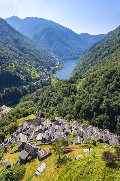 View of the town of Corippo, the town with less inhabitants of all Switzerland, and Lake Vogorno with Verzasca Dam. Corippo, Valle Verzasca, Canton Ticino, Switzerland.