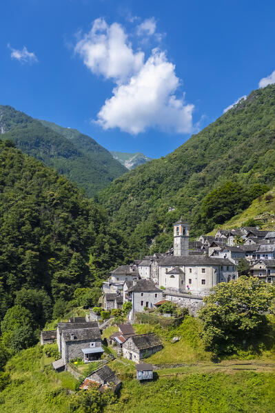 View of the town of Corippo, the town with less inhabitants of all Switzerland, and Lake Vogorno with Verzasca Dam. Corippo, Valle Verzasca, Canton Ticino, Switzerland.