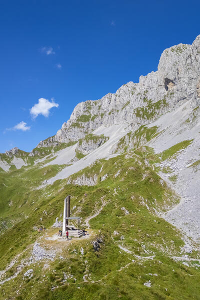Aerial view of the Presolana covered in clouds and the Città di Clusone bivouac at it's foothills. Passo della Presolana, Castione della Presolana, Val Seriana, Bergamo district, Lombardy, Italy.