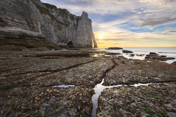 Sunset at the cliff and arch of Etretat, Octeville sur Mer, Le Havre, Seine Maritime, Normandy, France, Western Europe.
