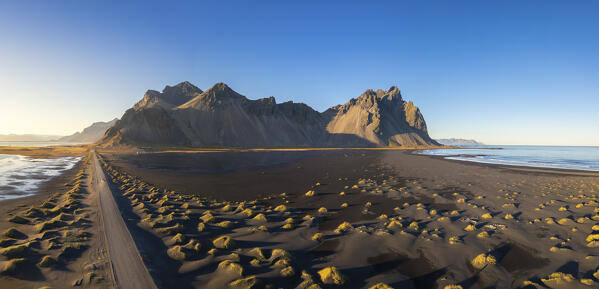 Aerial view of the black sand dunes in front of Vestrahorn mountain. Stokksnes peninsula, Hofn, Austurland, Iceland, Europe.