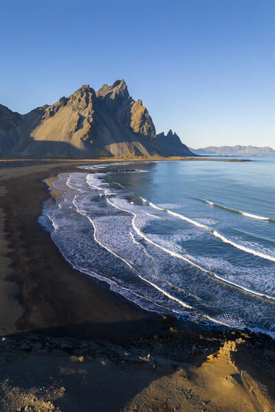 Aerial view of the black sand dunes in front of Vestrahorn mountain. Stokksnes peninsula, Hofn, Austurland, Iceland, Europe.