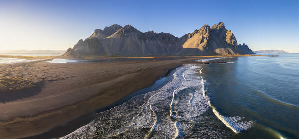 Aerial view of the black sand dunes in front of Vestrahorn mountain. Stokksnes peninsula, Hofn, Austurland, Iceland, Europe.