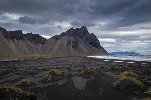 Aerial view of the black sand dunes in front of Vestrahorn mountain. Stokksnes peninsula, Hofn, Austurland, Iceland, Europe.