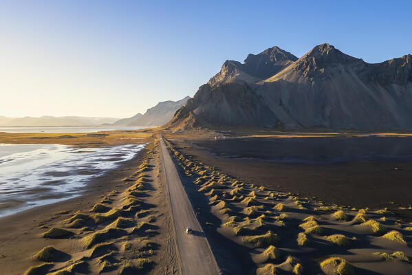 Aerial view of the black sand dunes in front of Vestrahorn mountain. Stokksnes peninsula, Hofn, Austurland, Iceland, Europe.