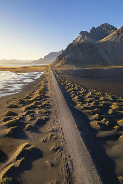 Aerial view of the black sand dunes in front of Vestrahorn mountain. Stokksnes peninsula, Hofn, Austurland, Iceland, Europe.