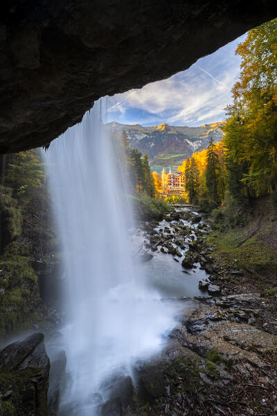 View of the Giessbach waterfalls and Grand Hotel in autumn at sunset. Iseltwald, Lake Brienz, Bernese Oberland, Interlaken-Oberhasli district, Canton of Bern, Switzerland.