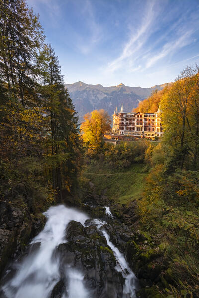 View of the Giessbach waterfalls and Grand Hotel in autumn at sunset. Iseltwald, Lake Brienz, Bernese Oberland, Interlaken-Oberhasli district, Canton of Bern, Switzerland.