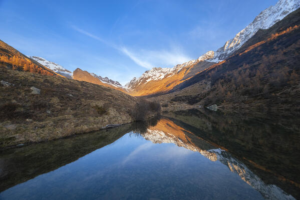 View of the Grundsee in Lotschental valley in autumn at sunset. Bernese Alps, canton of Valais, Switzerland.