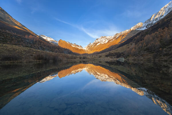 View of the Grundsee in Lotschental valley in autumn at sunset. Bernese Alps, canton of Valais, Switzerland.