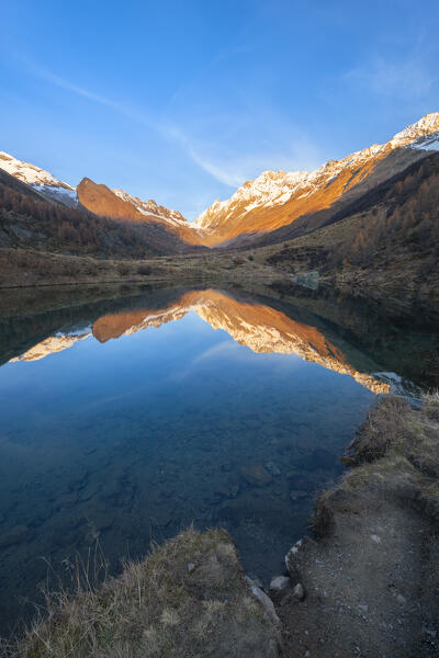 View of the Grundsee in Lotschental valley in autumn at sunset. Bernese Alps, canton of Valais, Switzerland.