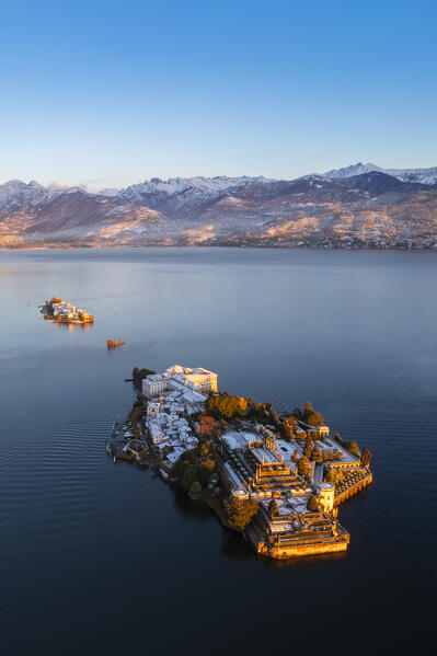 Aerial view of the Borromean Islands during a winter sunrise after a snowfall. Stresa, Lago Maggiore, Verbano Cusio Ossola district, Piedmont, Italy.