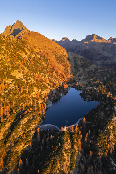 Aerial view of Lago del Becco in autumn at sunset. Branzi, Val Brembana, Alpi Orobie, Bergamo, Bergamo Province, Lombardy, Italy, Europe.