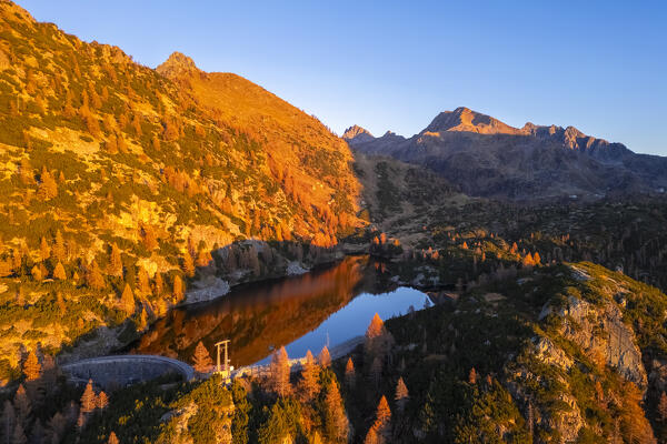 Aerial view of Lago del Becco in autumn at sunset. Branzi, Val Brembana, Alpi Orobie, Bergamo, Bergamo Province, Lombardy, Italy, Europe.