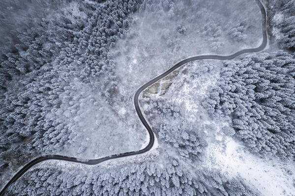Aerial view of the road to Monte Pora in winter after a snowfall. Val Seriana, Bergamo district, Lombardy, Italy.