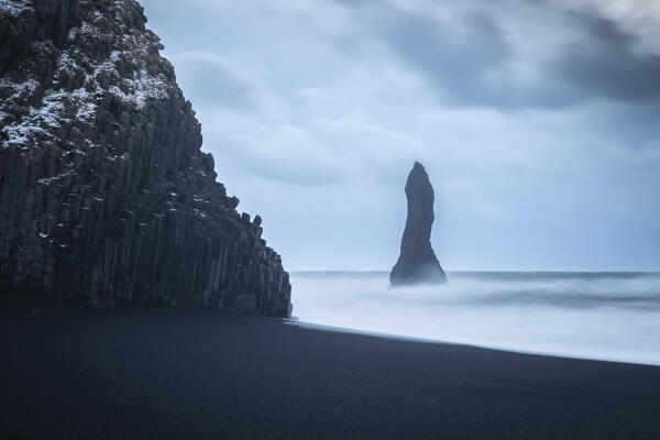 View of the basaltic columns and Reynisdrangar​ at Reynisfjara beach during sunrise in winter. Vík í Mýrdal, southern Iceland, Iceland, Northern Europe.