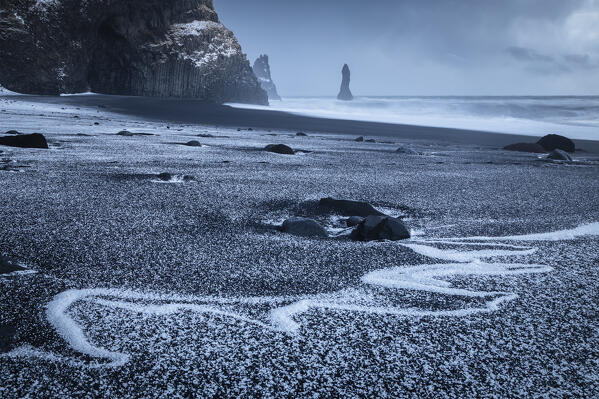 View of the basaltic columns and Reynisdrangar​ at Reynisfjara beach during sunrise in winter. Vík í Mýrdal, southern Iceland, Iceland, Northern Europe.