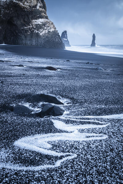 View of the basaltic columns and Reynisdrangar​ at Reynisfjara beach during sunrise in winter. Vík í Mýrdal, southern Iceland, Iceland, Northern Europe.