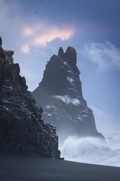View of the basaltic columns and Reynisdrangar​ at Reynisfjara beach during sunrise in winter. Vík í Mýrdal, southern Iceland, Iceland, Northern Europe.
