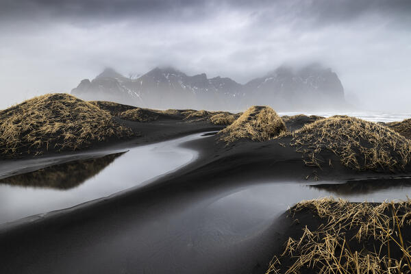 View of the black sand dunes in front of Vestrahorn mountain. Stokksnes peninsula, Hofn, Austurland, Iceland, Europe.