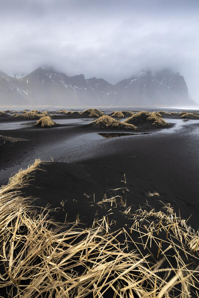 View of the black sand dunes in front of Vestrahorn mountain. Stokksnes peninsula, Hofn, Austurland, Iceland, Europe.