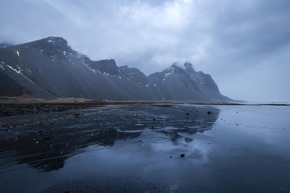 View of the Vestrahorn mountain reflected on the wet sands. Stokksnes peninsula, Hofn, Austurland, Iceland, Europe.