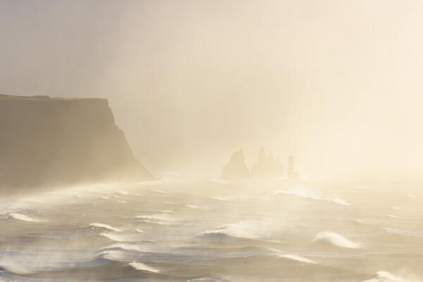 View of the sea stacks near Reynisfjara beach during sunrise in winter from Dyrholaey. Vík í Mýrdal, southern Iceland, Iceland, Northern Europe.