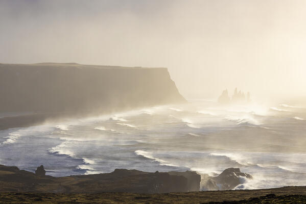 View of the sea stacks near Reynisfjara beach during sunrise in winter from Dyrholaey. Vík í Mýrdal, southern Iceland, Iceland, Northern Europe.