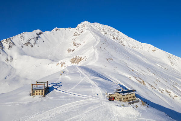 Aerial view of the Rifugio Capanna 2000 at the foothills of Pizzo Arera in winter covered in snow. Val Serina, Zambla Alta, Bergamo district, Lombardy, Italy, Southern Europe.
