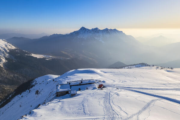 Aerial view of the Rifugio Capanna 2000 at the foothills of Pizzo Arera in winter in front of the Monte Alben. Val Serina, Zambla Alta, Bergamo district, Lombardy, Italy, Southern Europe.