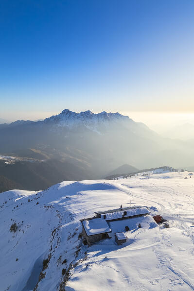 Aerial view of the Rifugio Capanna 2000 at the foothills of Pizzo Arera in winter covered in snow. Val Serina, Zambla Alta, Bergamo district, Lombardy, Italy, Southern Europe.
