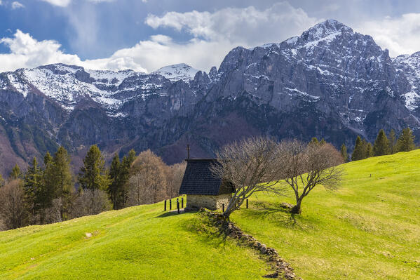 View of the small chapel of Pigolotta di Valtorta surrounded by meadows in spring. Valtorta, Bergamo province, Brembana valley, Lombardy, Italy, Europe.